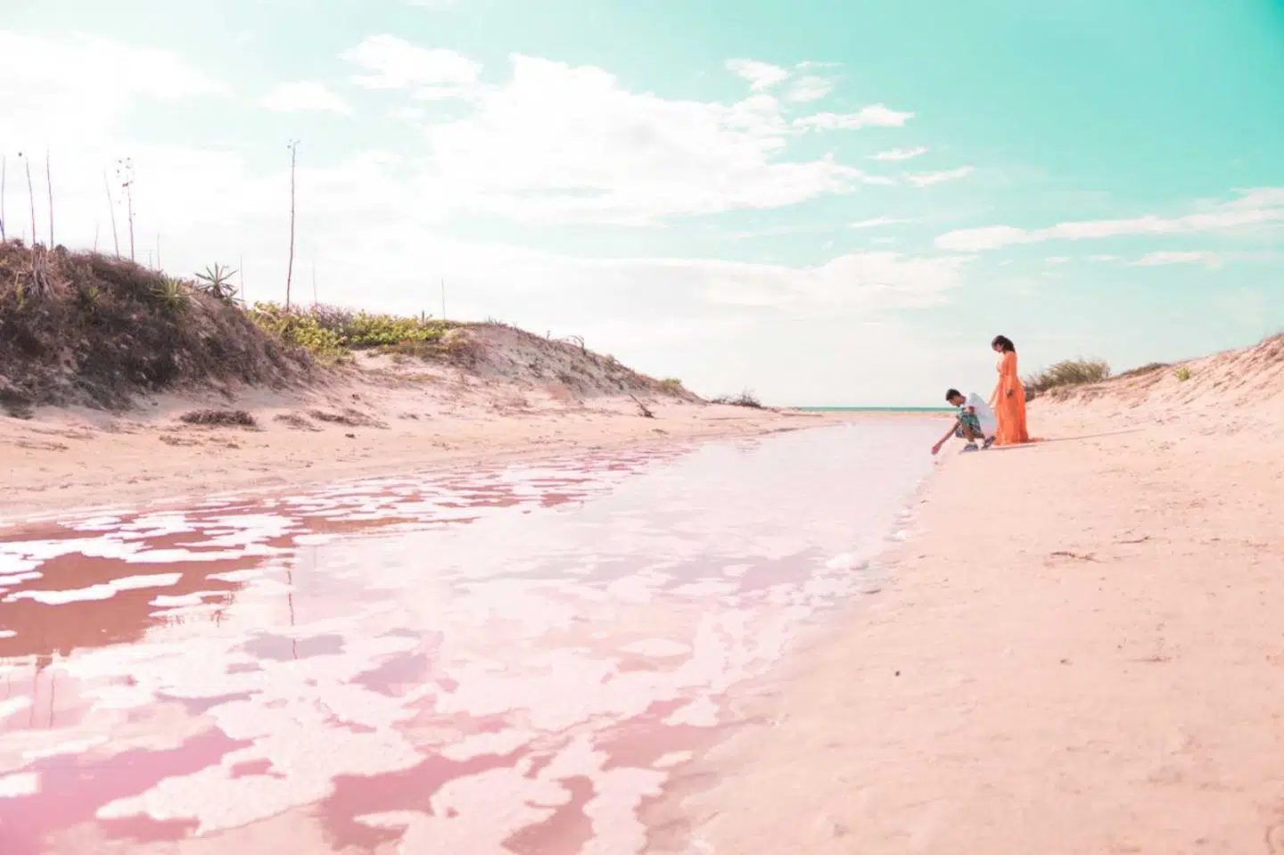 couple enjoying las coloradas pink lakes of mexico