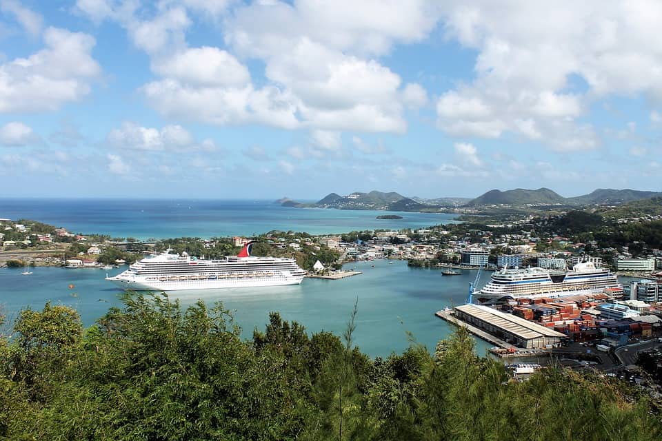 royal caribbean cruise ship sitting in harbor in aruba island
