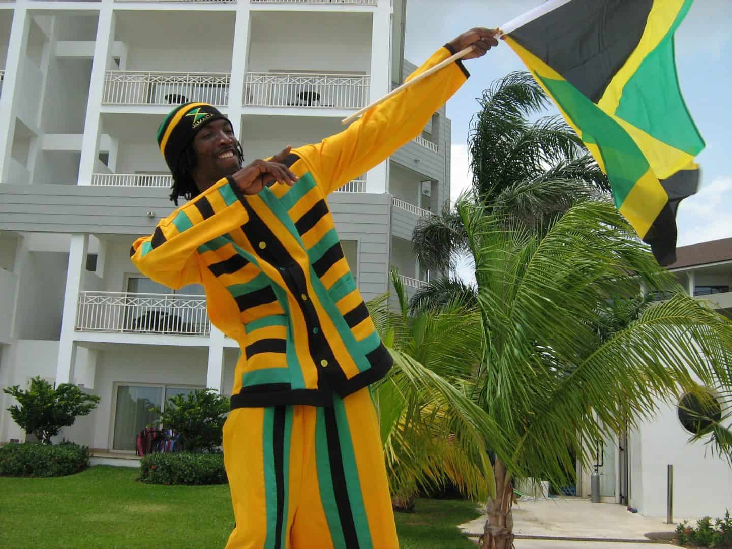 Jamaican person holding jamaican flag on independence day