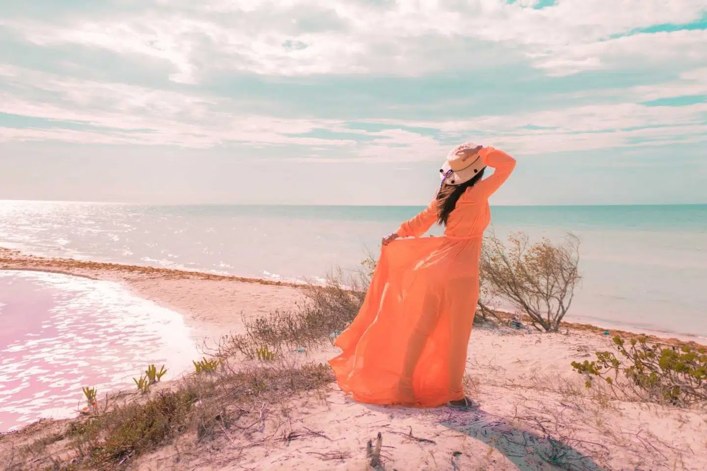 woman at los coloradas pink lakes with pink water