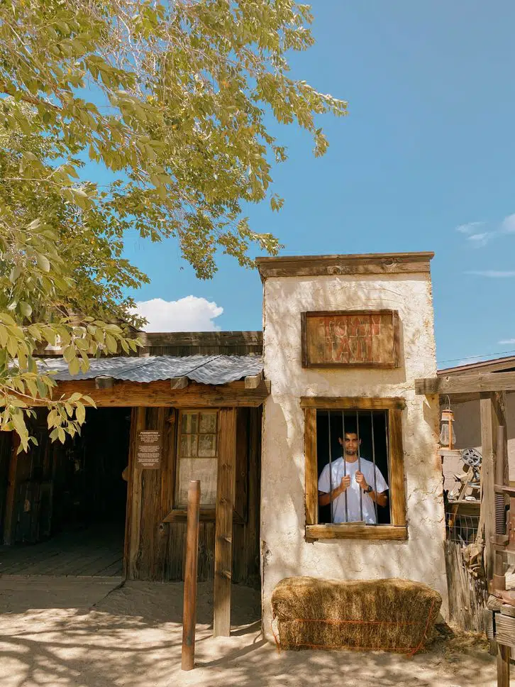 handsome man standing inside Pioneertown jail