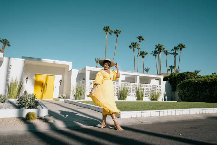 beautiful woman in front of colorful door house in palm springs door tour