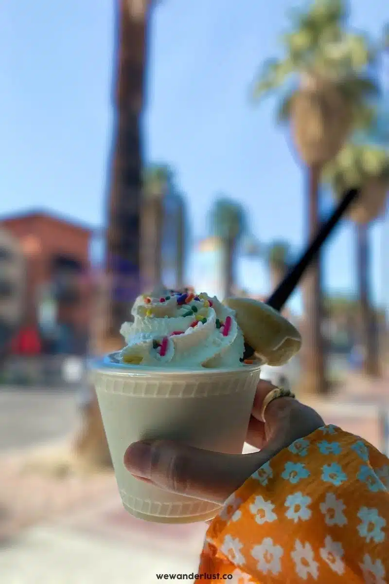 woman holding up ice cream cup