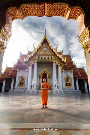 buddhist monk standing in a temple