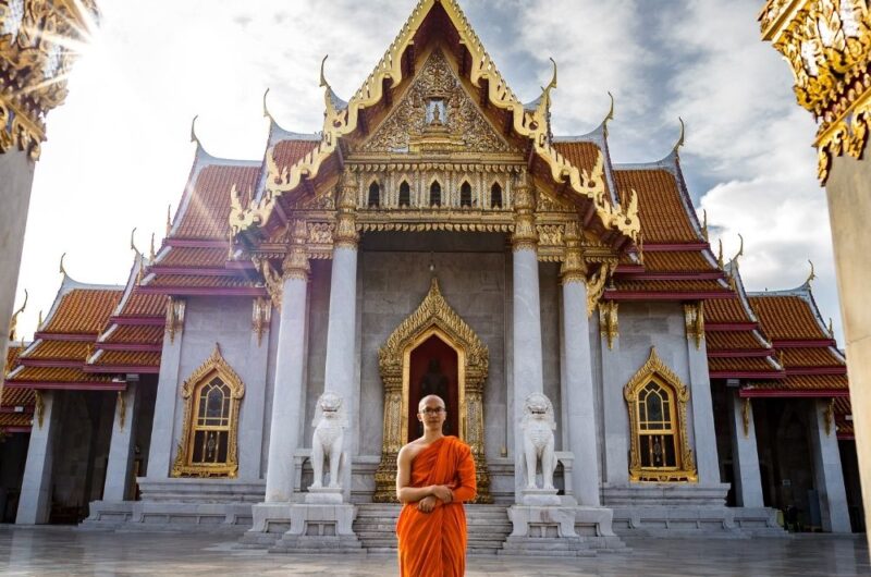 buddhist monk standing in a temple