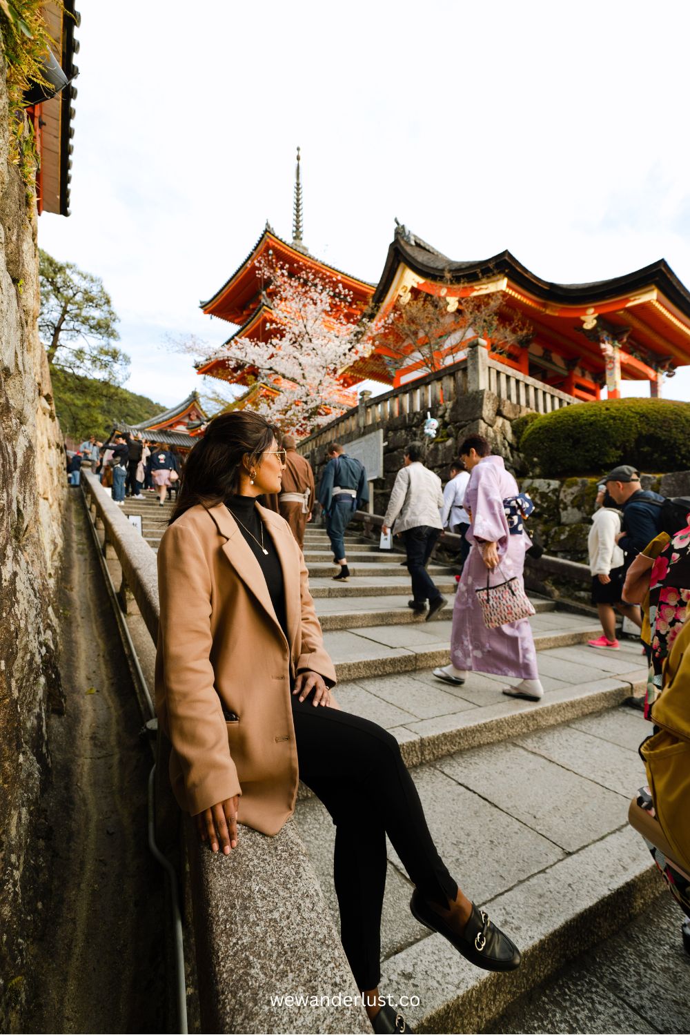 woman-sitting-by-temple-in-kyoto-japan-wewanderlustco