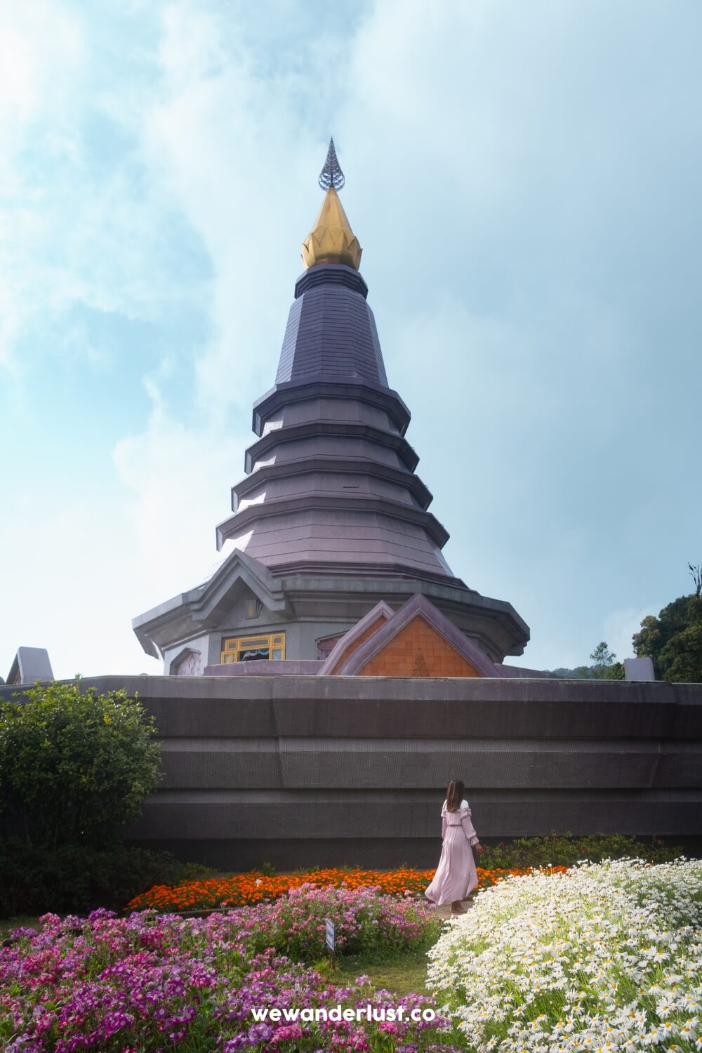 woman standing by pagoda at doi inthanon pagodas in thailand