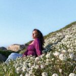 beautiful woman sitting in wildflowers