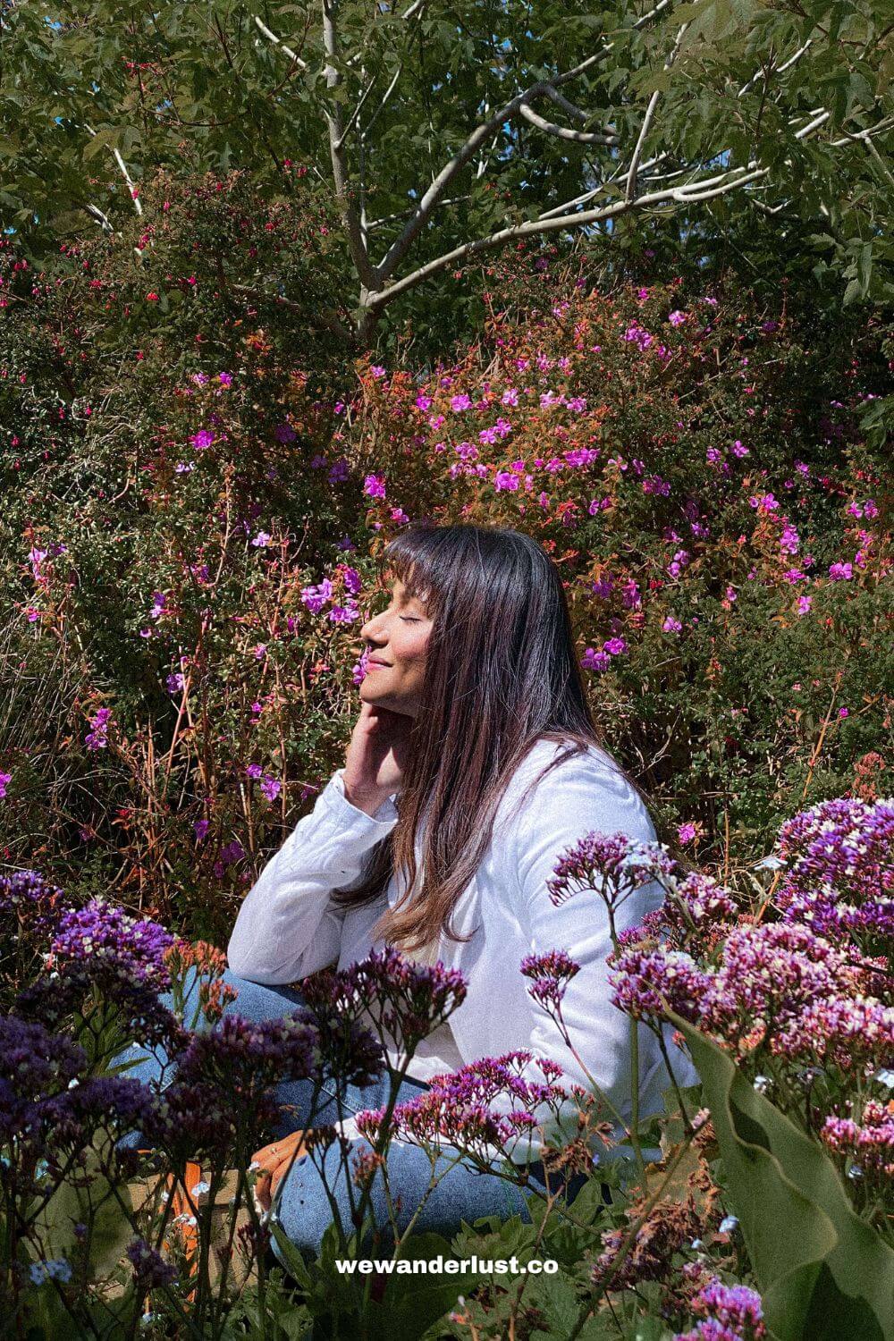 woman sitting around flowers at San Francisco Botanical Garden